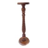 A turned wood jardinière stand with an elongated pine cone-style stem (95cm high)