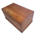 A 19th century polished pine trunk of good colour; the hinged lid opening to reveal candle box