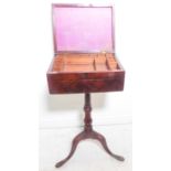 An early 19th century mahogany workbox-on-stand – the hinged lid opening to reveal compartmentalised