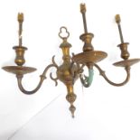 A heavy three-light brass wall-mounting candelabra for restoration