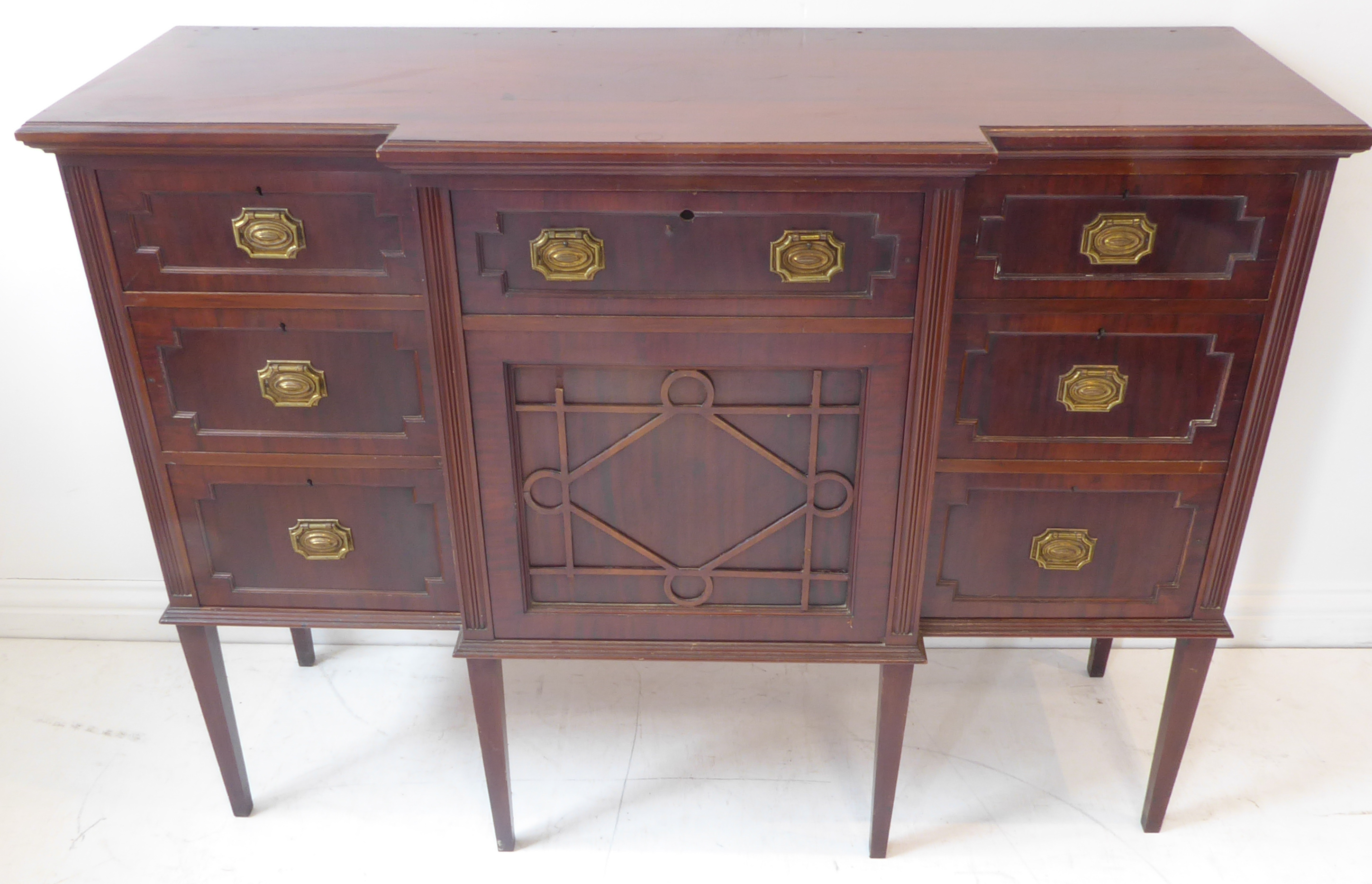 An early 20th century mahogany side cabinet in late 18th century George III style – the breakfront