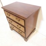 A Georgian-style mahogany chest of small proportions –  reeded edge top above three full-width