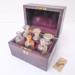 A 19th century rosewood-cased six-division apothecary bottle set (three with stoppers), vacant