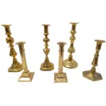 A pair of heavy cast-brass candlesticks (weighted) and four other candlesticks (some 19th century)