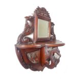 A Victorian mahogany hanging shelf with mirrors – original bevelled edge glass panels, one square