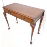 An early 20th century mahogany side table in Georgian-style – the thumbnail moulded top above a