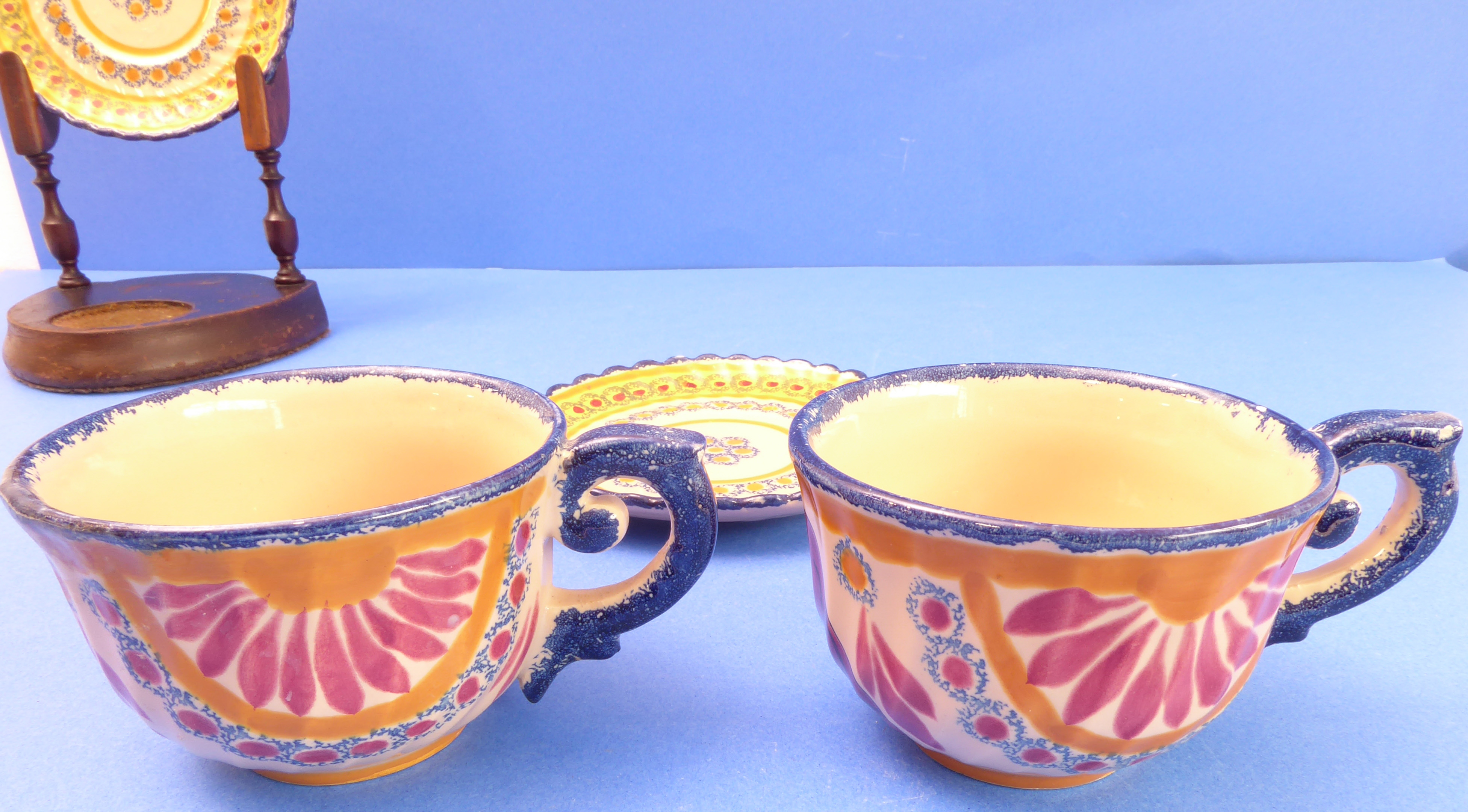 A pair of 1930s French Art Deco cups and saucers signed Luchon; one cup with male figure wearing a - Image 2 of 4