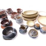 A good selection of studio pottery bowls including cups, saucers, jugs (tallest 11cm), a condiment