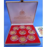 A boxed set of nine proof commemorative medallions (possibly Thai silver-gilt) with accompanying