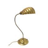 A student-style brass lamp with shell-shaped reflectorThe lamp has not been PAT tested; the cable