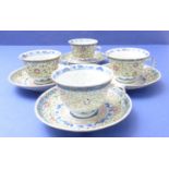 A set of four Chinese porcelain cups and saucers; hand-decorated in enamels, the cups with
