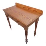 A 19th century Oregon pine writing/side table; the galleried top above two half-width drawers and