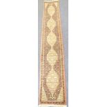 A good hand-knotted wool pile Persian-style runner –  five cream lozenges with various stylised