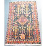 A heavy pure wool hand-knotted Eastern carpet – central lozenge against a dark ground with elongated
