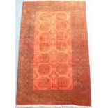 A Pakistan Belouch-style rug with gul pattern against a red ground (wear) (183cm x 118cm)