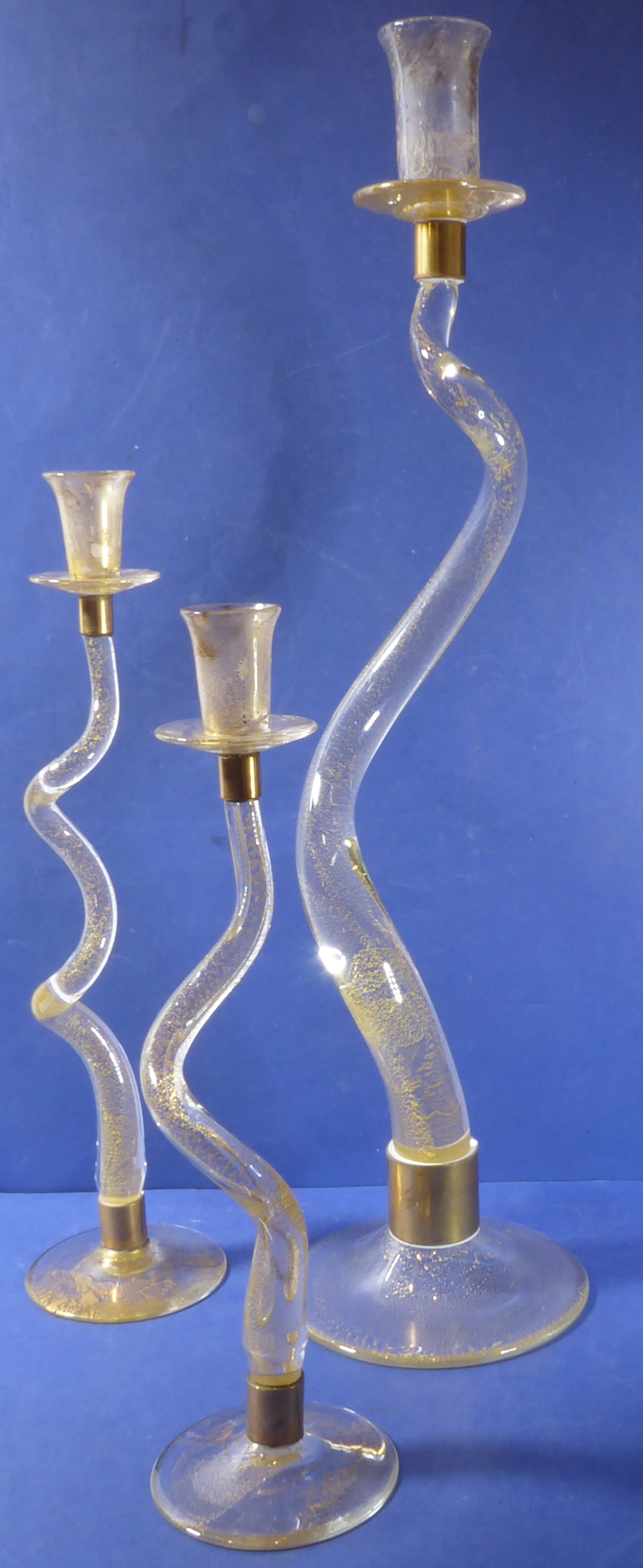 A set of three designer gold-fleck crystal candlesticks (signed)
