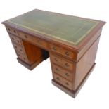 An early 20th century mahogany pedestal desk; the moulded gilt tooled green leather inset top