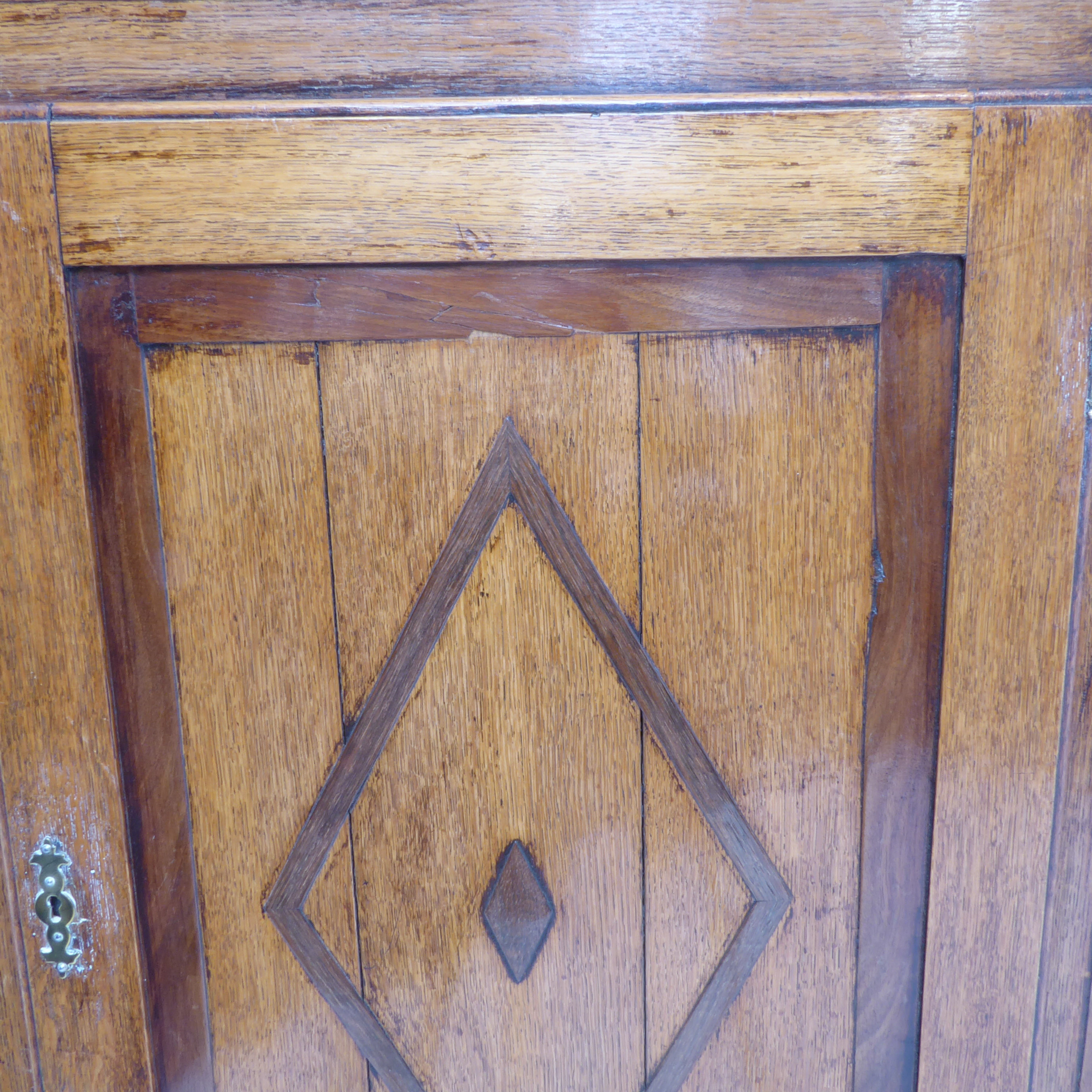 A late 18th century George III period oak and banded hanging corner cupboard; the panelled door - Image 2 of 3
