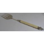 A hallmarked silver muffin fork with an ivory handle