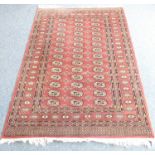 A hand-knotted Pakistan belouch carpet –  three-row gul pattern against a red ground (180cm x
