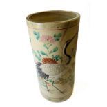 An early 20th century Japanese pottery vase of cylindrical form; hand-decorated in enamels in relief
