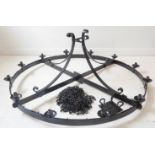 A very large wrought-iron ceiling-hanging candelabra; twelve-light circular design (129cm in