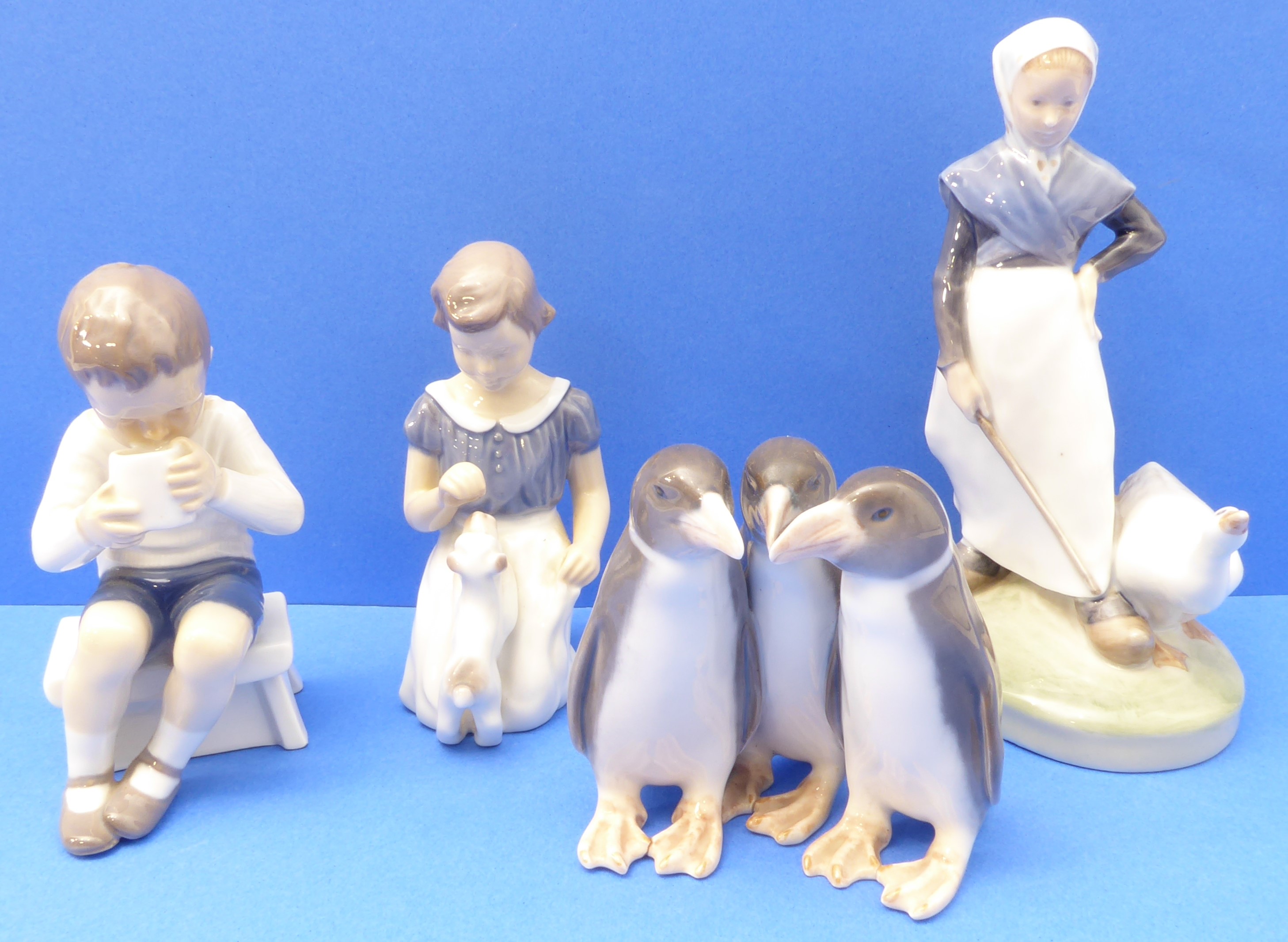 Four mid-20th century Royal Copenhagen porcelain figures (Danish factory): a young girl with