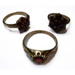 Three garnet-set cluster rings, the first with diamond-set detail to each shoulder, hallmarked 9-