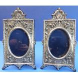A pair of Britannia Standard silver photograph frames - decorated with floral swags and urns in