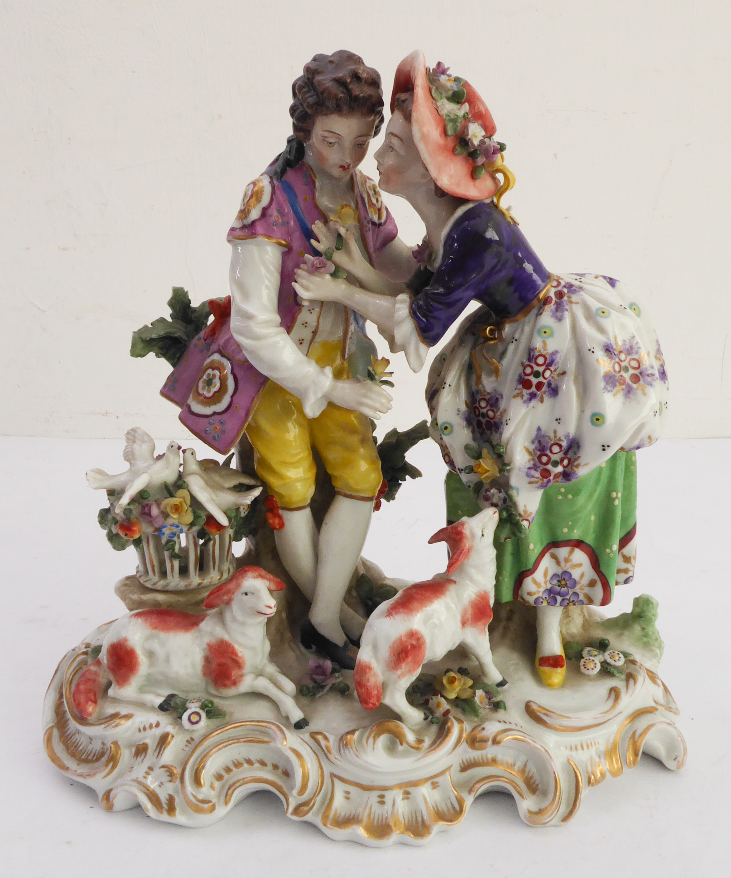 A hand-decorated late 19th / early 20th century Naples porcelain figure group - the female receiving
