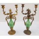 A pair of 19th century gilt-metal-mounted porcelain two-light table candelabra: in the Louis XV