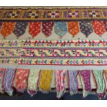 A large and interesting selection of Indian nomadic hand-stitched wall-hangings and torans (