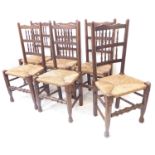 A set of six heavy oak and rush seated country chairs in late 18th/early 19th century style (later);