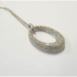 A white gold, one-carat diamond-set pendant and chain