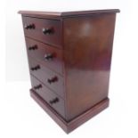 A four-drawer mahogany table cabinet in 19th century style raised on plinth base (32.5cm wide x 26cm
