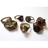 Seven gem-set dress rings, including an oval synthetic corundum ring, the shank stamped '14K',