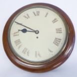 An early 20th century circular mahogany-framed Schoolmaster's style clock; cream dial with Roman