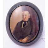 A 19th century ebonised framed oval portrait miniature brooch/pendant; central oval porcelain insert