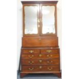 A tall mahogany mirror fronted cabinet (made up from three pieces of 18th century furniture); the