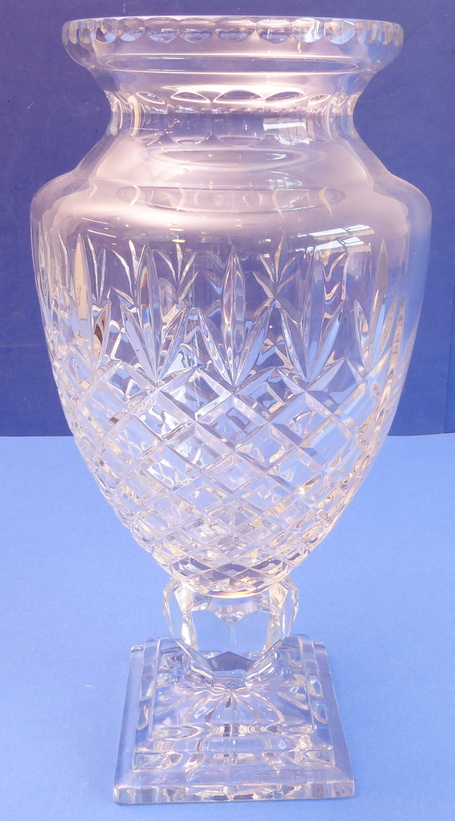 A large and heavy hand-cut clear-glass vase of baluster form - diamond-cut body above a stepped