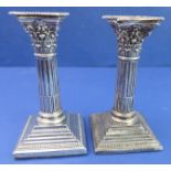 A pair of late 19th century hallmarked silver (filled) table candlesticks – modelled as Corinthian