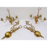 A pair of ceiling-hanging four-light brass candelabra, together with a pair of brass wall