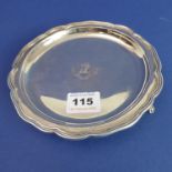 An Edwardian hallmarked silver salver; raised reeded edge surrounding an engraved armorial with