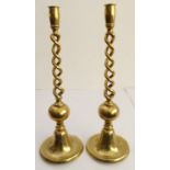 A pair of large and heavy cast brass table candlesticks of open barleytwist form and each on bell-
