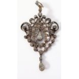 An Edwardian diamond-set pendant of openwork scrolling cartouche design, set throughout with old