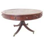 A large Regency period circular mahogany drum table; the distressed leather inset moulded top