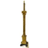 A carved giltwood standard lamp: modelled as a classical-style column with composite capital; the