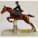 A hand-decorated Beswick model of a lady jumping a six-log fence side-saddle - printed and painted