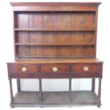 A George III period, 18th century, oak dresser: the outset cornice above a shelved superstructure;