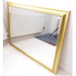A large and modern gilt-framed wall-hanging mirror having hand-bevelled plate (103cm x 131.5cm)